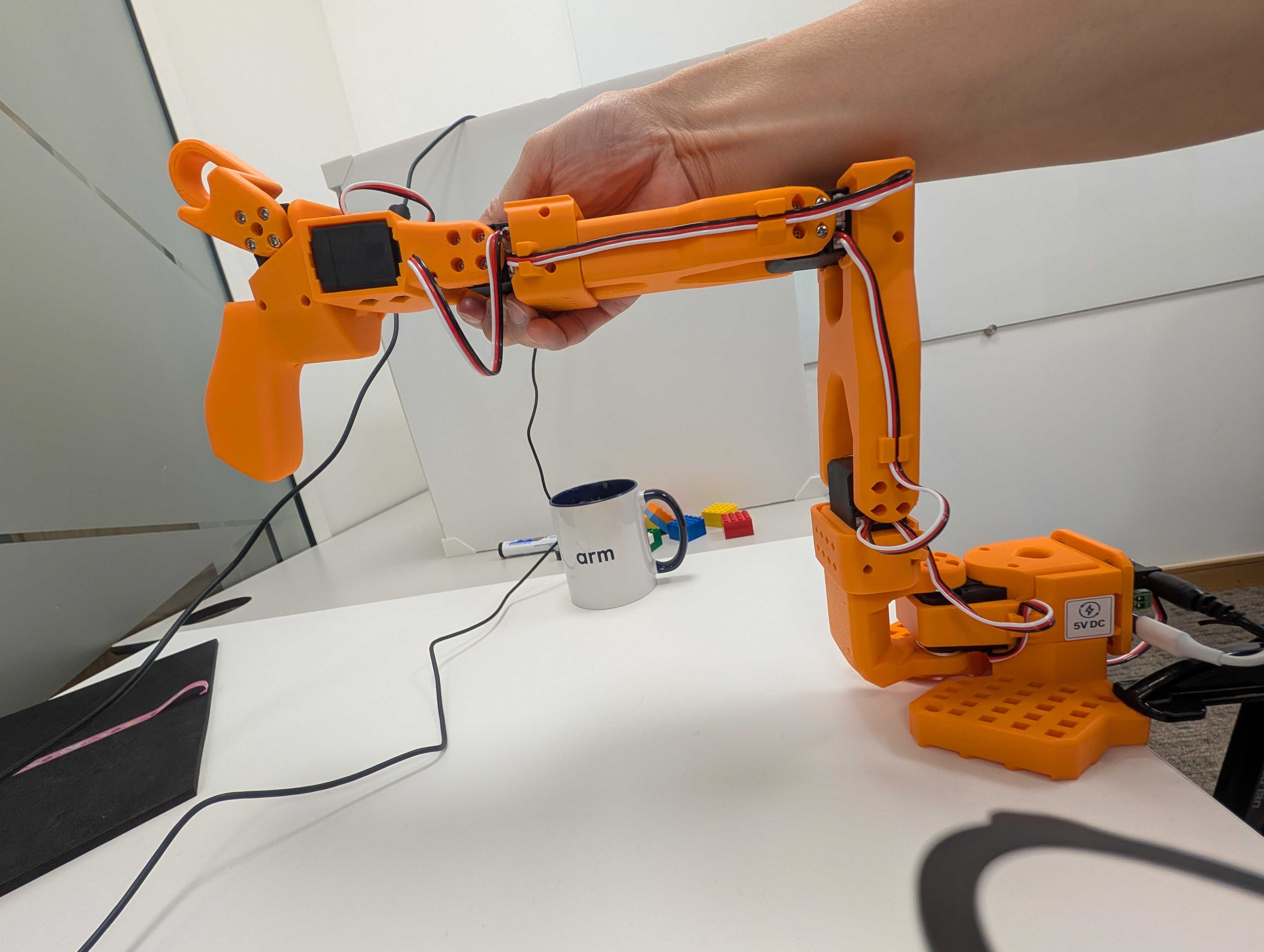 Image Alt Text:Leader SO-101 supported in the middle-range starting pose before calibration begins. Its shoulder, elbow, wrist, and gripper are positioned away from their motion limits.